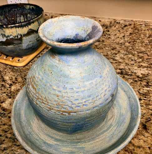 a large stone ware vase on a plate created by potter Ron Zemetres
